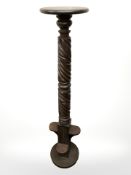 A carved and stained torchere,