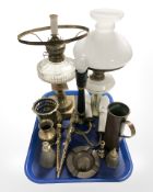 A brass oil lamp with clear glass reservoir (converted), a further lamp, pair of wall lights,