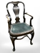 An Edwardian oak armchair in the Queen Anne style, with studded draylon seat, width 56 cm.