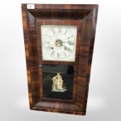 A 19th century continental rosewood veneered wall clock, height 65 cm.