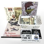 Group of reproduction tin advertising signs, wooden sign with Woody Woodpecker, St James Park sign,