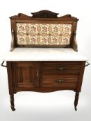 An Art Nouveau walnut tiled backed wash stand with white marbled top,