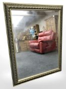 A reproduction gilt bevelled mirror, 116 cm x 91 cm.