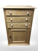 A 19th century pine cabinet, fitted three drawers and cupboard beneath, 70 cm x 48 cm x 113 cm.