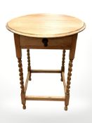 An early 20th century oak barley twist single drawer occasional table, diameter 61 cm.