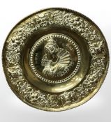 An embossed brass charger,