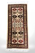 An Azerbaijani rug, 150 cm x 60 cm.