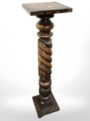 A carved and stained pine barley twist torchere,