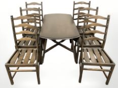 An Ercol stained elm drop leaf dining table and six ladder back chairs