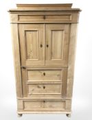 A 19th century pine single door cabinet, on bun feet, 101 cm x 54 cm x 185 cm.