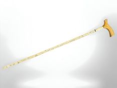 A shark vertebrae walking stick, with wooden handle, length overall 86 cm.