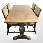 A reproduction oak 5' refectory dining table and four chairs in brass studded tapestry fabric