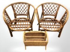 A pair of wicker armchairs and a further magazine rack.