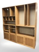 A 20th century oak veneered four section modular open bookcase, fitted cupboards beneath,