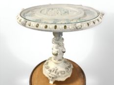 An oriental style painted plaster occasional table with plate glass top,