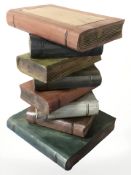 A contemporary lamp table in the form of a stack of books,