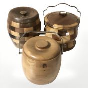 Three wooden biscuit barrels, two with ceramic liners.