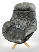 A contemporary Scandinavian grey leather swivel armchair on bentwood support