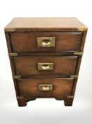 A mahogany campaign-style three drawer chest with brass drop handles,