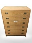 A 20th century Danish oak veneered six drawer chest, with brass drop handles,