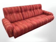 A late 20th century Scandinavian three seater lounge settee, in striped red fabric,