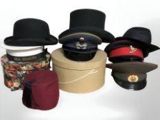 Various hats including a black felt derby hat, a fez, reproduction Soviet officers cap,