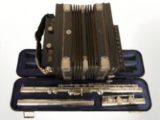 An Evette chrome plated flute, in carry case, and a concertina.