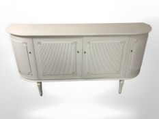 A painted and gilt bow front sideboard, 161 cm x 42 cm x 80 cm.