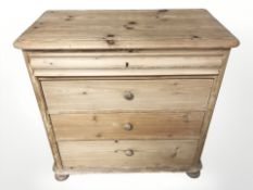 A 19th century pine four drawer chest on bun feet,