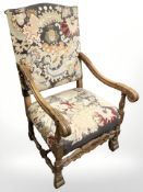 A continental heavily carved oak armchair in tapestry fabric,