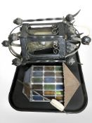 A leaded stained glass wall light and a further wrought iron wall light.