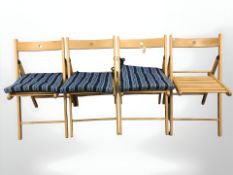 A set of four folding beech chairs.