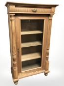 A late 19th century continental oak glazed cabinet,