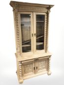 An early 20th century continental glazed double door bookcase,