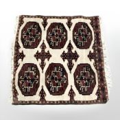 A small Turkoman rug, Afghanistan, 57 cm x 54 cm.