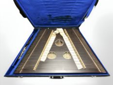 A Zither labelled Musima, Made in German Democratic Republic, in travel case.