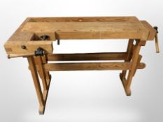 A 20th century pine work bench fitted with a vice,