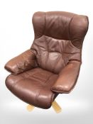 A Danish Burgundy leather swivel lounge chair on bentwood support