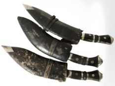 Three kukri knives.