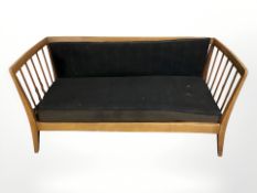 A mid 20th century continental walnut spindle back hall settee,