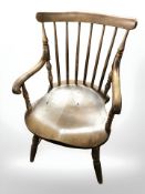 A beech spindle back armchair.