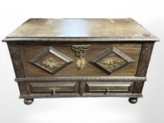 A reproduction oak Zanzibar chest with brass mounts,