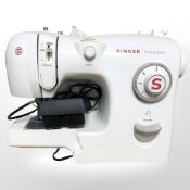 A Singer Inspiration electric sewing machine, with lead and pedal.