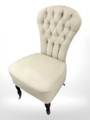A Victorian lady's chair in buttoned upholstery.