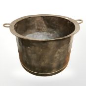 A 19th century copper twin handled cooking pot, diameter 56 cm.