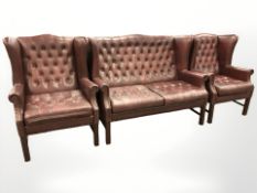 A 20th century oxblood button leather two seater settee, width 127 cm,