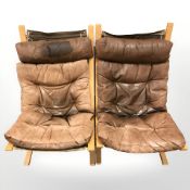 A pair of 20th century Danish bentwood and brown buttoned leather lounge chairs designed by Ingmar
