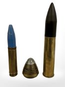Three inert ammunition shells, tallest 27cm.