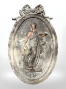 A cast iron oval plaque depicting a Greek lady, 50 cm x 31 cm.