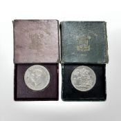 Two 1951 Festival of Britain five shilling coins in boxes.